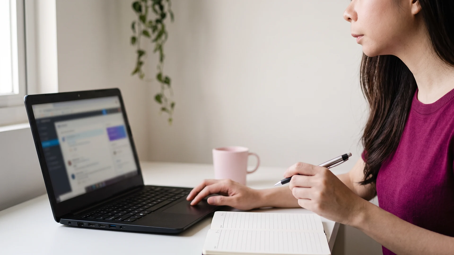 Shopify store owner at a laptop comparing chatbot and AI agent options for her store