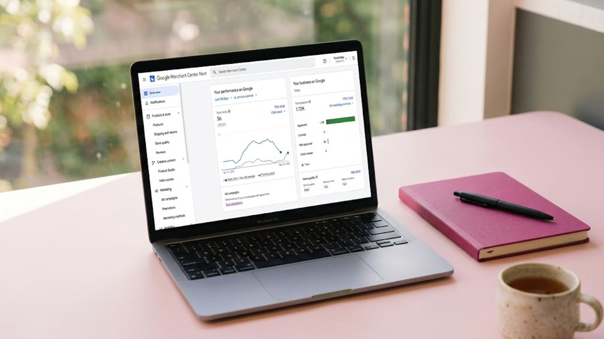 Laptop showing the Google and YouTube channel inside Shopify admin on a soft pink desk