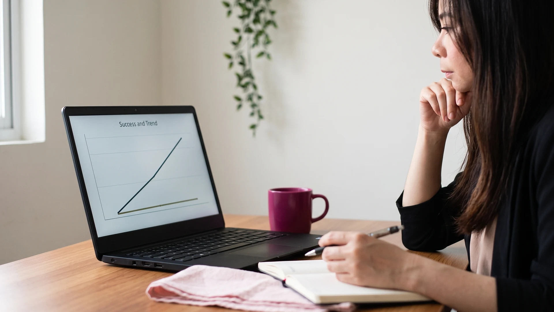 Shopify store owner reviewing a zero-click search analytics chart on a laptop at a calm desk